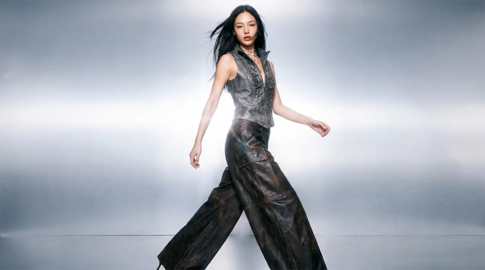AI fashion model in leather vest and trousers on bright studio backdrop