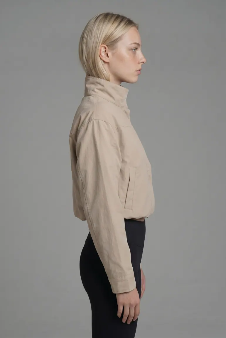 Model in beige jacket, side profile
